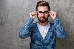 Handsome young bearded man wearing the eyeglasses photo