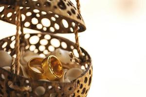 Close-up of golden wedding rings inside coconut shell photo