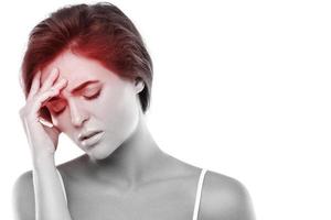 Woman with a source of red painful headache photo