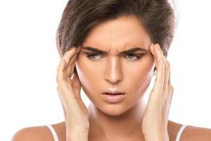 Woman with painful headache on white background photo