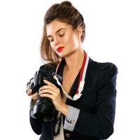 Woman photographer with a DSLR camera on white background photo