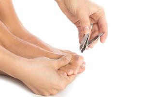 Closeup of Female feet and nail clipper photo