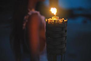 Close-up of bamboo torch light on the beach photo
