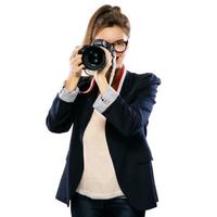 Woman photographer with a DSLR camera on white background photo