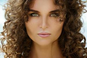 Portrait of beautiful young woman with curly hair photo