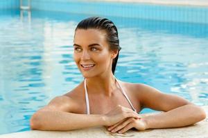 Portrait of beautiful woman in the swimming pool photo