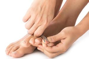 Closeup of Female feet and nail scissors photo