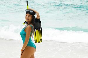 Beautiful young woman after snorkeling on the beach photo