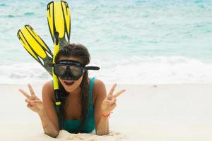 Beautiful young woman after snorkeling on the beach photo