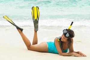 Beautiful young woman after snorkeling on the beach photo