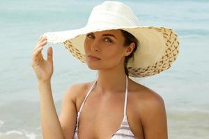 Portrait of beautiful woman wearing beach hat photo