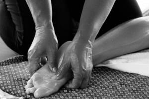 Closeup of female feet during traditional Thai massage photo