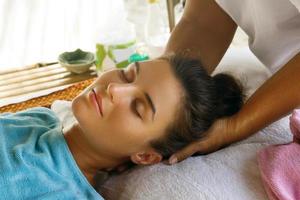 Young caucasian woman during traditional Thai massage photo