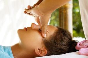 Young caucasian woman during traditional Thai massage photo