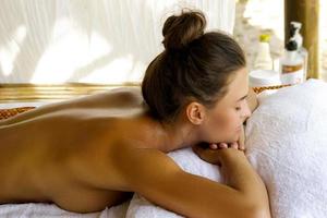 Young caucasian woman during traditional Thai massage photo