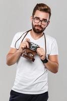 Photographer man with retro camera in studio photo