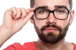 Handsome bearded man in eyeglasses on white background photo