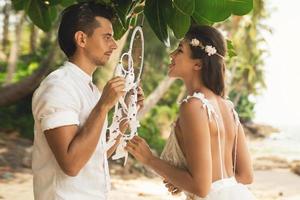 Just married couple is celebrating their wedding on the beach photo