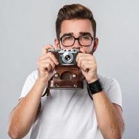 Photographer man with retro camera in studio photo