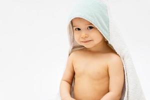 Cute baby with a hooded towel after a bathing photo