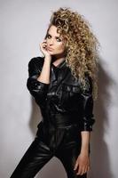 Sexy woman with a stylish Afro hairstyle wearing leather biker suit photo