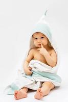 Cute baby wrapped into hooded towel after a bathing photo