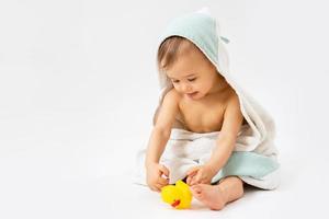 Cute baby wrapped into hooded towel after a bathing photo