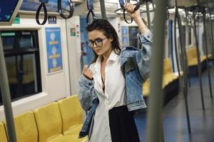 Sexy model is posing in carriage of metro train photo