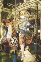 Stylish woman wearing sparkling jacket on the carousel photo