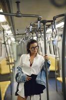 Sexy model is posing in carriage of metro train photo