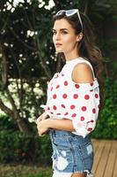 Beautiful young woman is wearing shirt with polka dot print photo