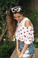 Beautiful young woman is wearing shirt with polka dot print photo