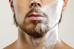 Man with a shaving cream on his face photo