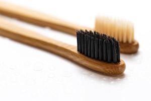 Eco friendly bamboo toothbrushes on white background photo