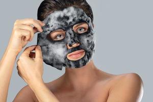 Woman with bubble sheet mask on her face photo