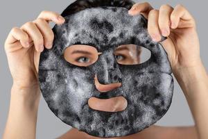 Woman with bubble sheet mask on her face photo