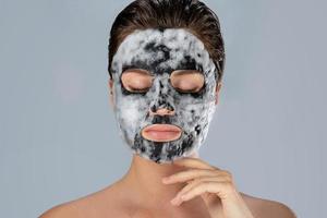 Woman with bubble sheet mask on her face photo