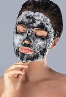 Woman with bubble sheet mask on her face photo