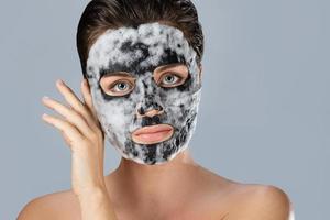 Woman with bubble sheet mask on her face photo