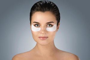 Woman with hydrating eye patches under her eyes o photo