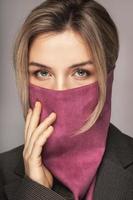 Woman wearing stylish leather bandana instead of prevention mask. photo