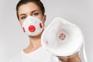 Woman is put on a face mask on someone for protection against virus photo