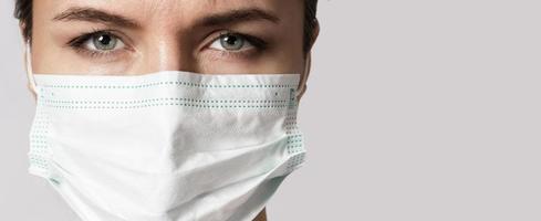 Young woman is wearing a face mask for protection against virus photo