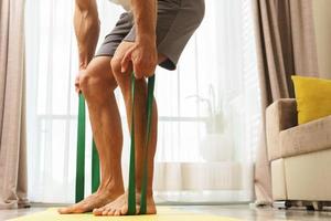 man during home workout with a resistance rubber bands photo