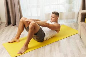 Man doing abs exercises during intense home workout photo