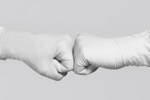 White gloves for mockup. Two medical workers making a fist bump gesture. photo