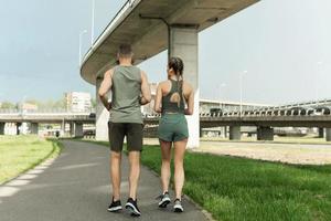 Sportive couple during jogging workout on city street photo