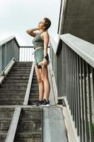 Sportive woman after fitness or jogging workout on a city street photo