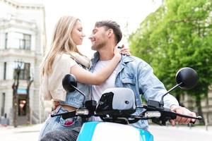 Stylish couple with a motorcycle on a city street photo