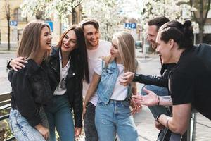 Group of best friends are having fun on a street photo